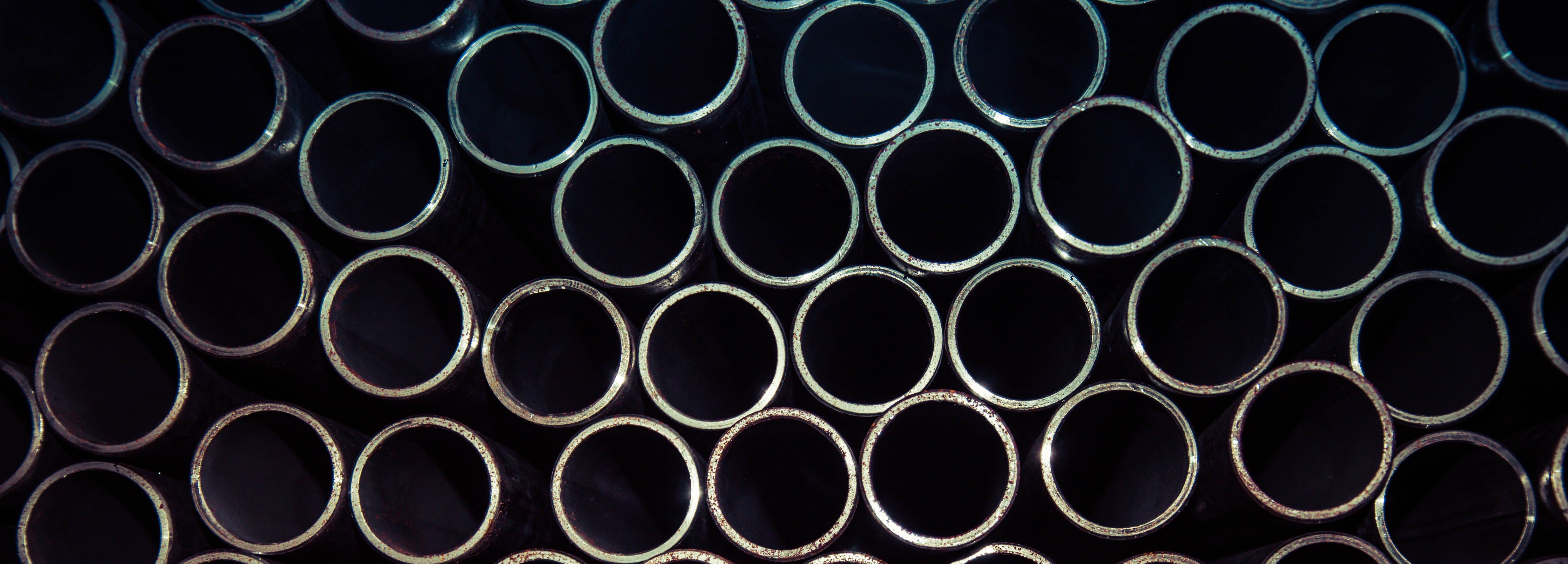 A picture of a wall pipes from the front opening of all of them.