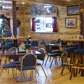A picture of the inside of the saloon boasting the decor and the wooden furniture.