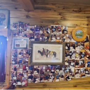 A picture of the inside of the saloon boasting the decor and the wooden furniture.